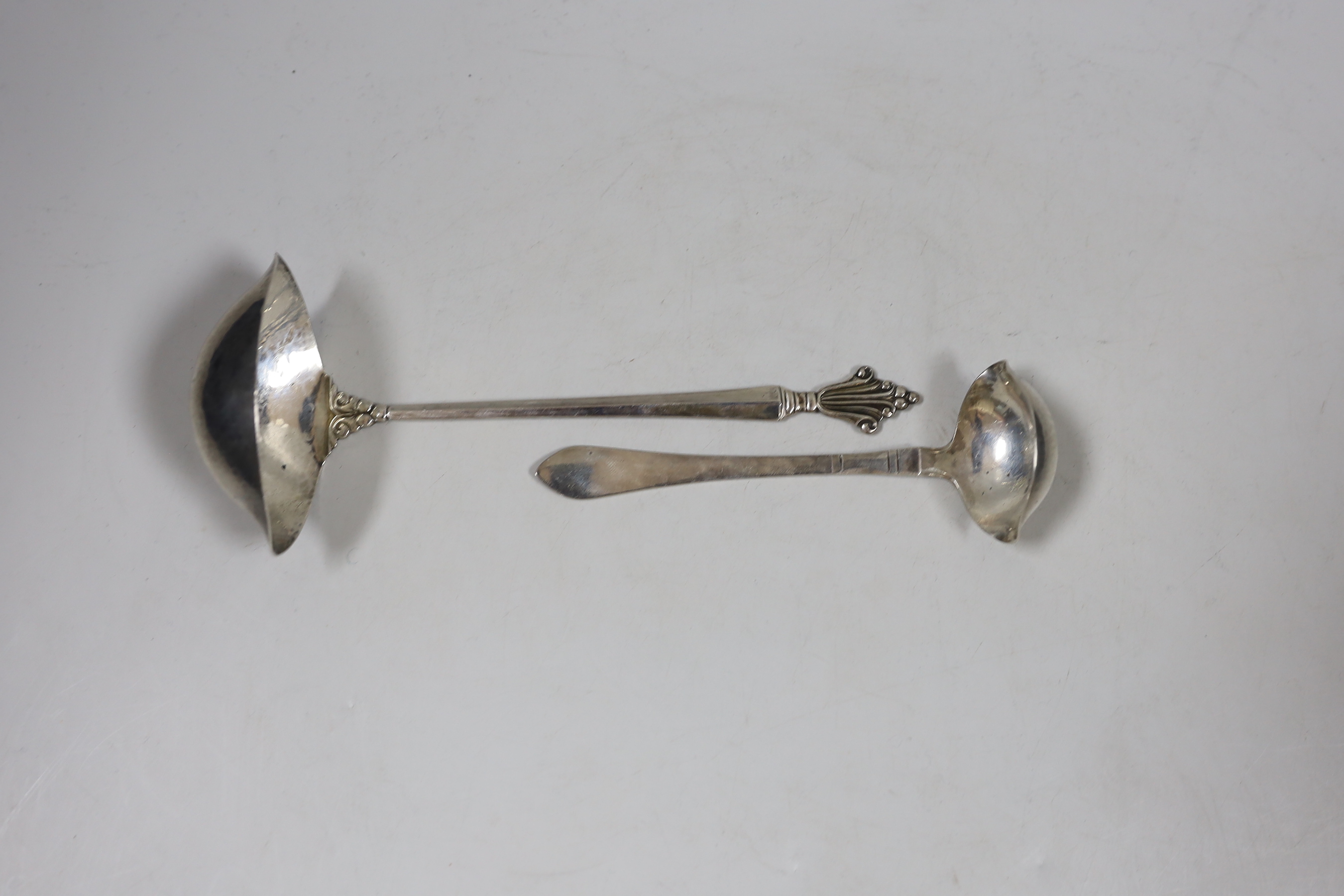 Two Georg Jenson sterling silver ladles, import marks for London, 1926, largest 19cm.